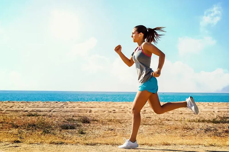 Female jogger running at the beach.