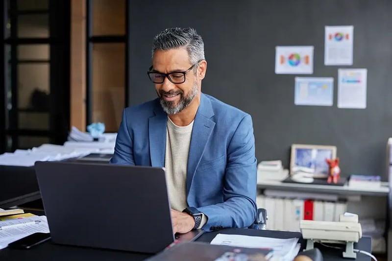 Man at a desk with a laptop computer.