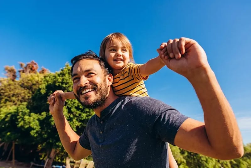 Father and son piggyback ride.