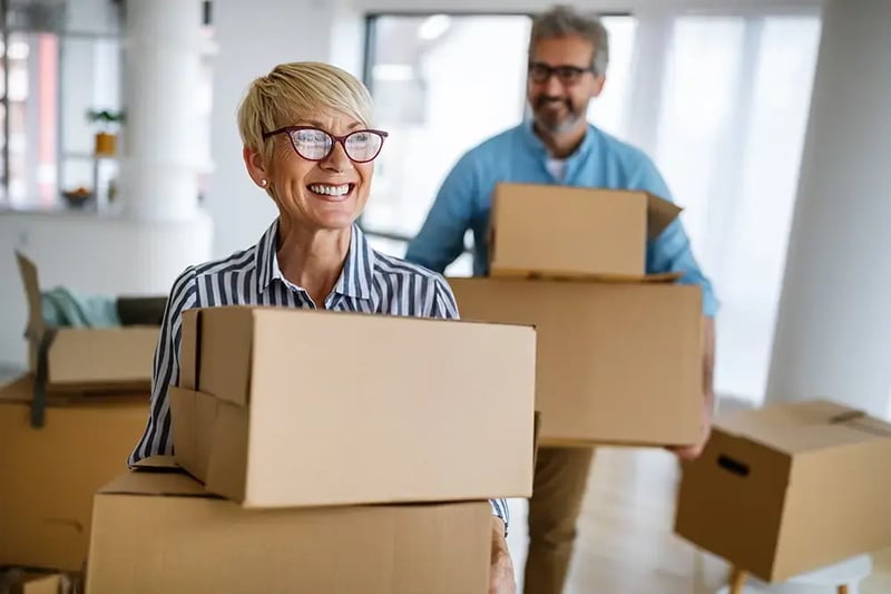 Older couple with moving boxes.