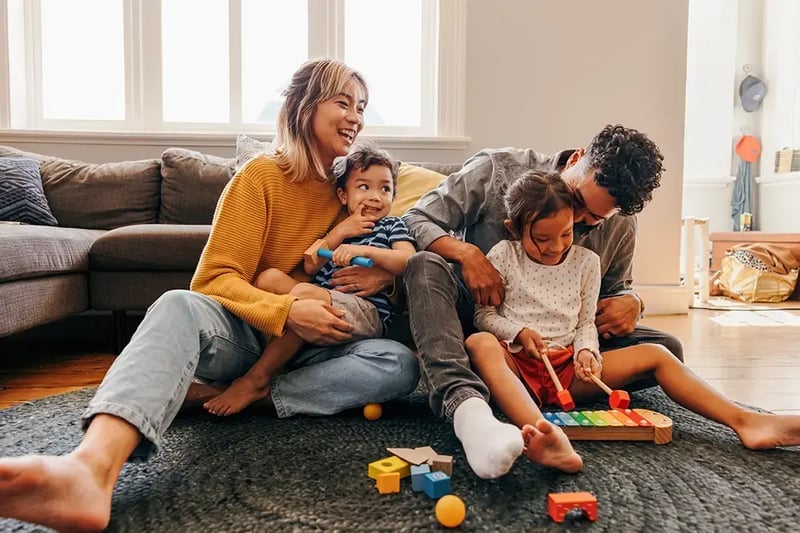 Happy family playing on the floor.