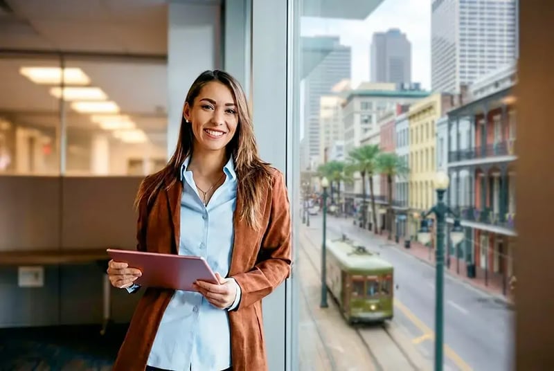 Woman in office with a tablet.