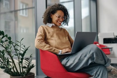 Woman working on a laptop computer.