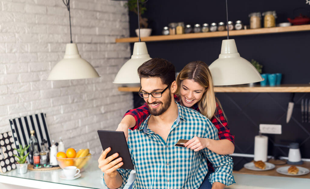 Shot of a women holding a credit card and purchasing online.