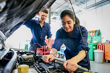 female mechanic working on a car