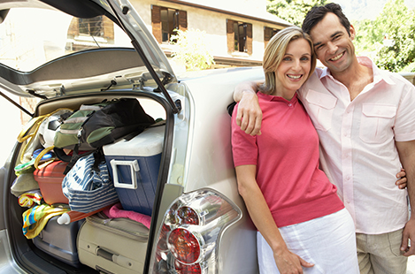 Couple packing up car for a road trip