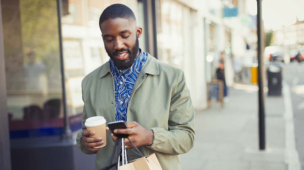 Person shopping while using their cell phone