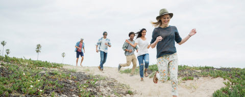 group-of-friends-running-on-beach