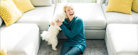 smiling-woman-wth-dog-in-living-room