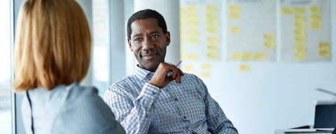 Photo of a two coworkers talking in an office