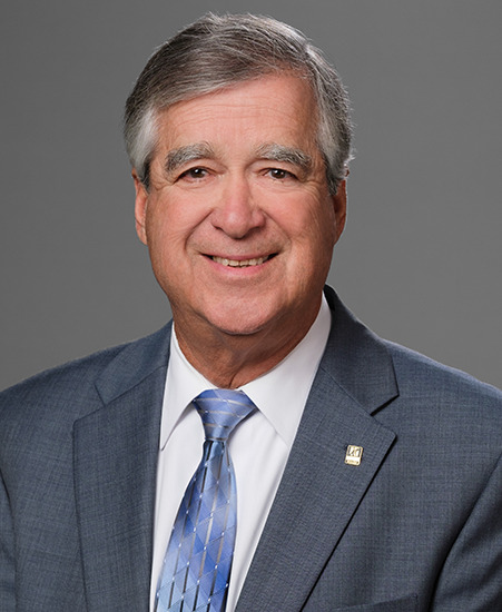 Portrait image of a person wearing a business suit