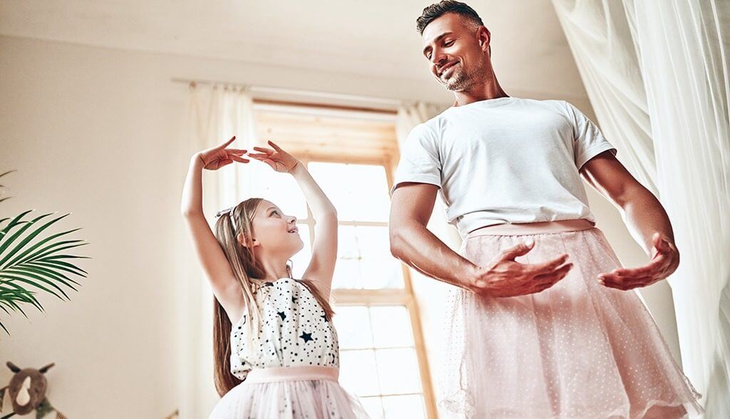 Dad and daughter in tutus ballet dancing