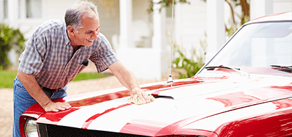 Person cleaning their classic car.