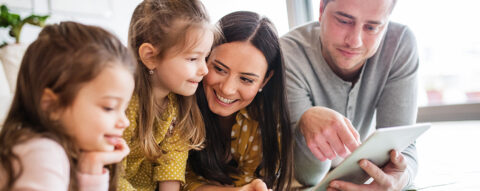 Family looking at a tablet together