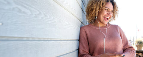 Person listening to music outside their new home