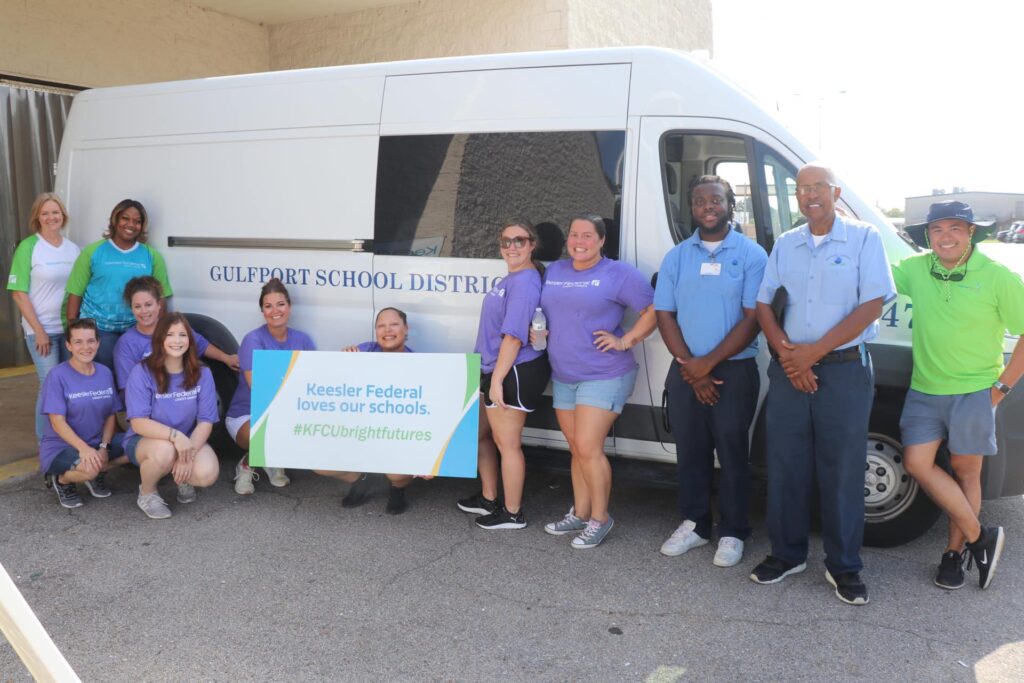 Keesler Federal employees distributing backpacks to school