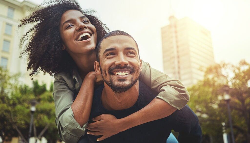 Man carrying woman on back