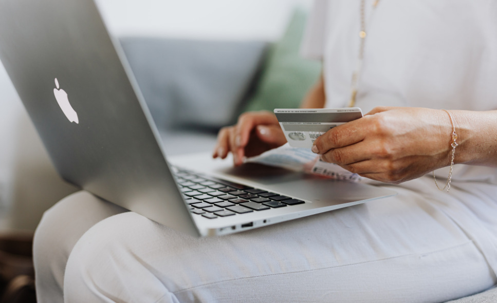 person entering credit card info on computer